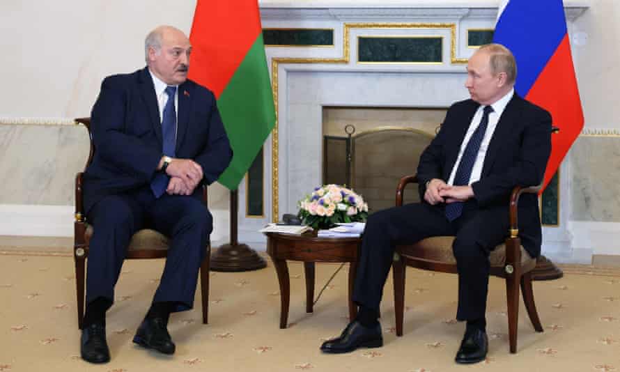 Russian President Vladimir Putin (R) speaks with his Belarusian counterpart Alexander Lukashenko during their meeting in Saint Petersburg, on June 25, 2022.