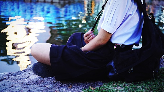 Close-Up Of Schoolgirl Sitting Outdoors