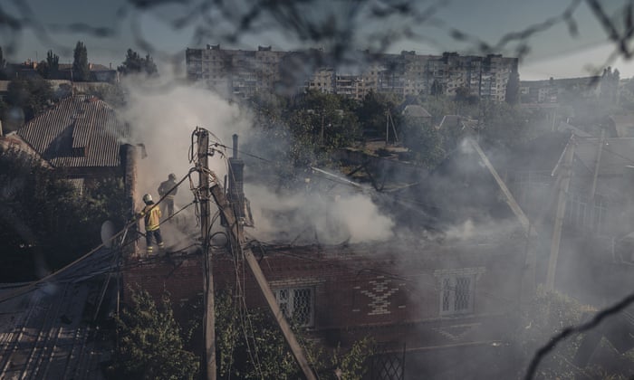 Firefighters try to extinguish a blaze in a shelled house in Bakhmut, Ukraine, on Saturday