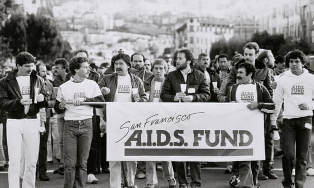 people walk with banner that says san francisco aids fund