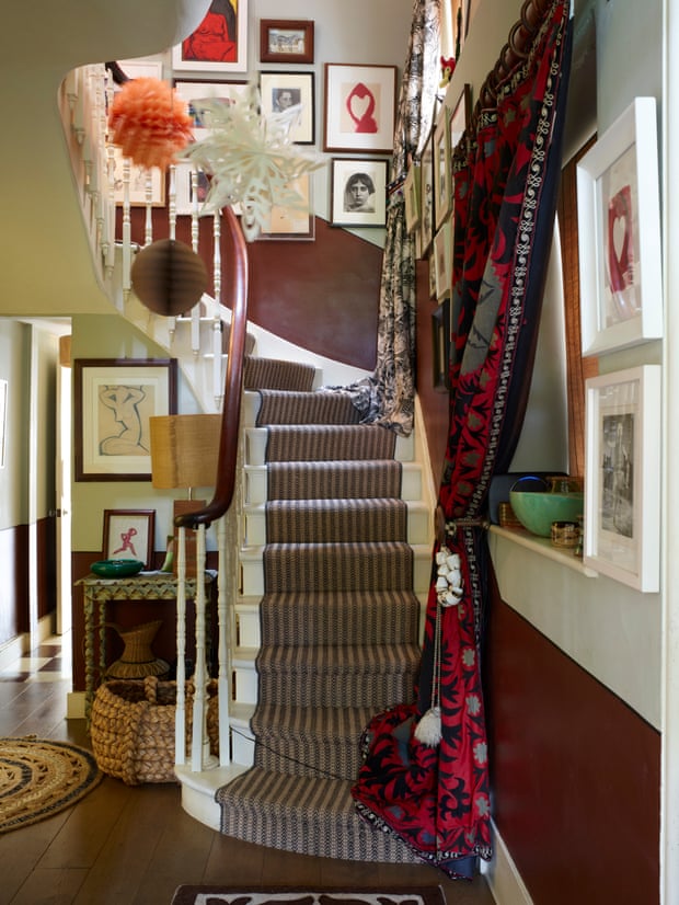 ’I’m never happier than when I’ve got a project’: an impressive gallery of photography on the stairs with a lilac-grey and plum two-tone hallway.