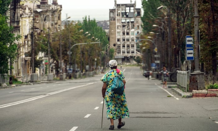 A woman walks along a ruined street in Mariupol on August 27, 2022, amid the ongoing Russian military action in Ukraine. (Photo by STRINGER / AFP) (Photo by STRINGER/AFP via Getty Images)