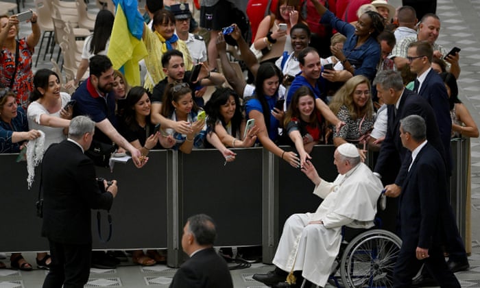 Pope Francis, sits on a wheelchair, leaves after his weekly general audience in the Paul VI hall, Vatican City.