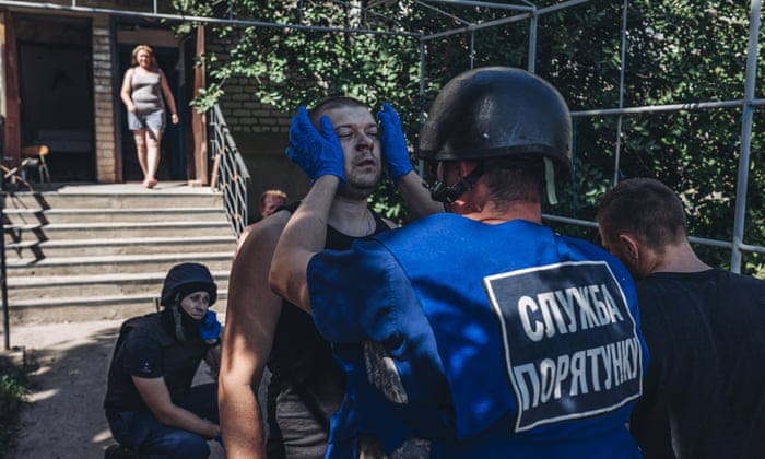 Ukrainian emergency services attend to an injured man in Opytne, Ukraine.